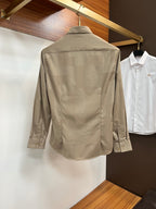 Taupe long-sleeve button-up shirt back view with pointed collar on a hanger