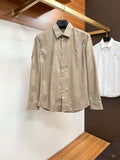 Beige long-sleeve button-up shirt with pointed collar and front button placket