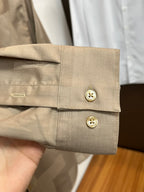 Beige shirt sleeve cuff with two buttons and folded cuff edge