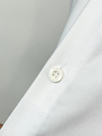 Burberry long-sleeve shirt cuff with white button and stitched placket on white fabric