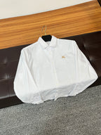 Burberry long-sleeve white button-up shirt with gold crest on chest