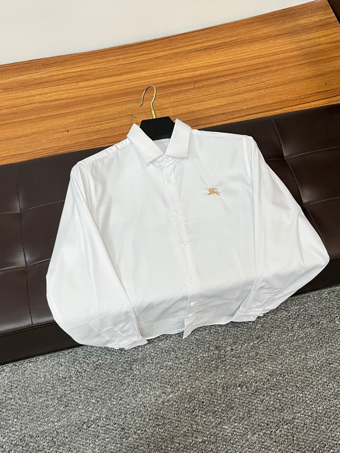 Burberry long-sleeve white button-up shirt with gold crest on chest