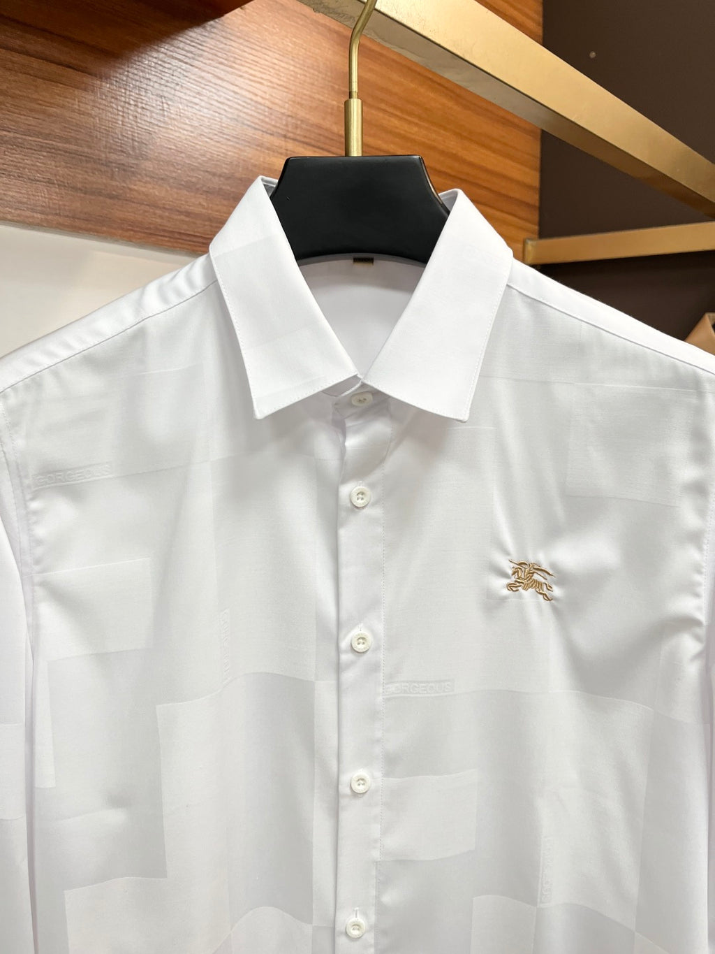 Burberry long-sleeve white shirt with point collar, button front, and gold crest