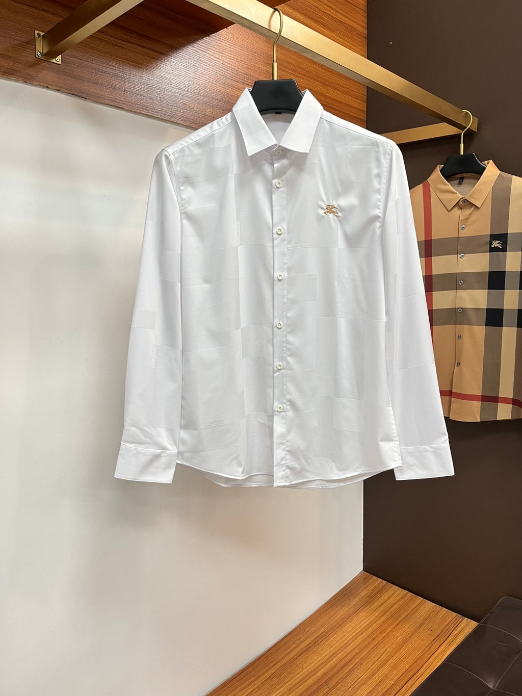 Burberry long-sleeve button-up shirt in white, with gold crest and front buttons