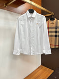 Burberry long-sleeve button-up shirt in white, with gold crest and front buttons