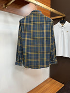Back view of a blue and yellow plaid dress shirt with long sleeves