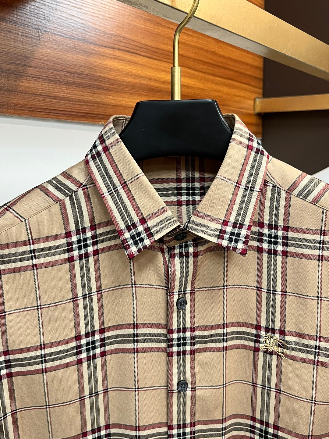 Beige plaid long-sleeve button-up shirt with pointed collar and button front