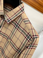 Beige plaid long-sleeve button-up shirt detail at shoulder and sleeve cuff