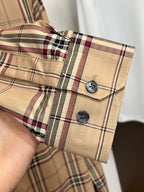 Beige plaid long-sleeve button-up shirt cuff with two dark button closures