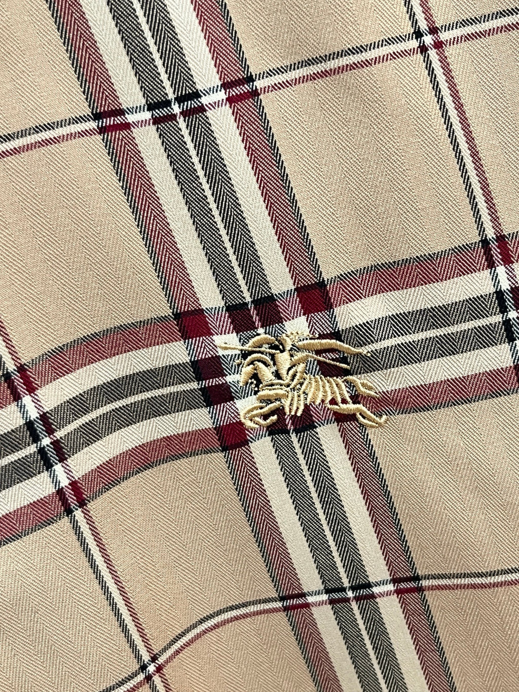 Beige plaid long-sleeve shirt chest detail with embroidered logo