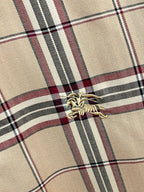 Beige plaid long-sleeve shirt chest detail with embroidered logo