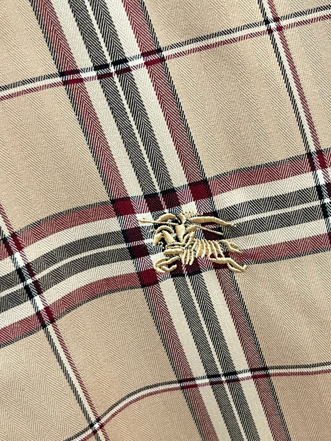Beige plaid long-sleeve shirt chest detail with embroidered logo