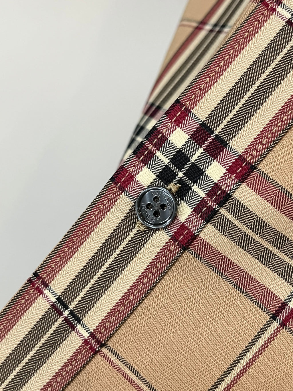 Beige plaid long-sleeve button-up shirt placket with round button