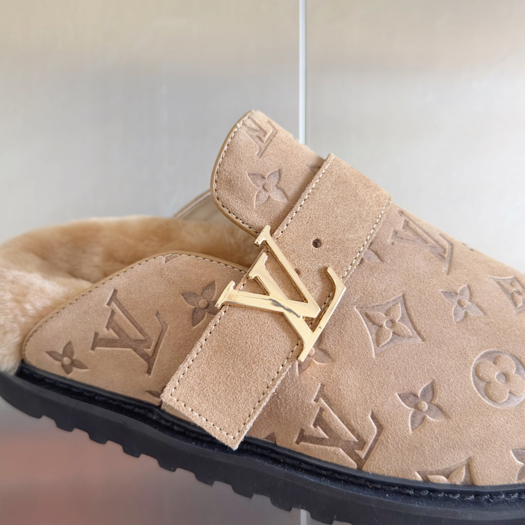Monogram slide sandal buckle detail on beige suede with strap.