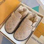 Monogram slide sandals with buckle straps and fuzzy lining, tan.