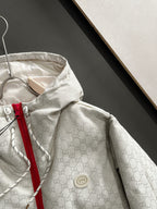 Gucci hooded jacket close-up, light-gray monogram, circular logo patch