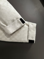 Gucci jacket button strap detail on light-gray monogram sleeve cuff