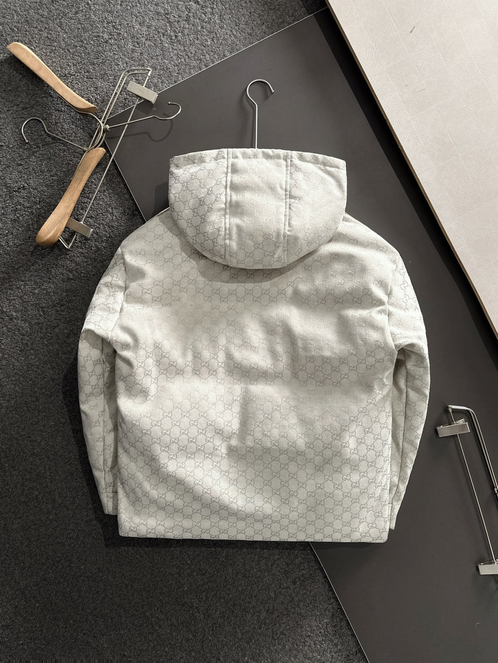 Gucci hooded jacket back view, light-gray monogram, central hood and pockets
