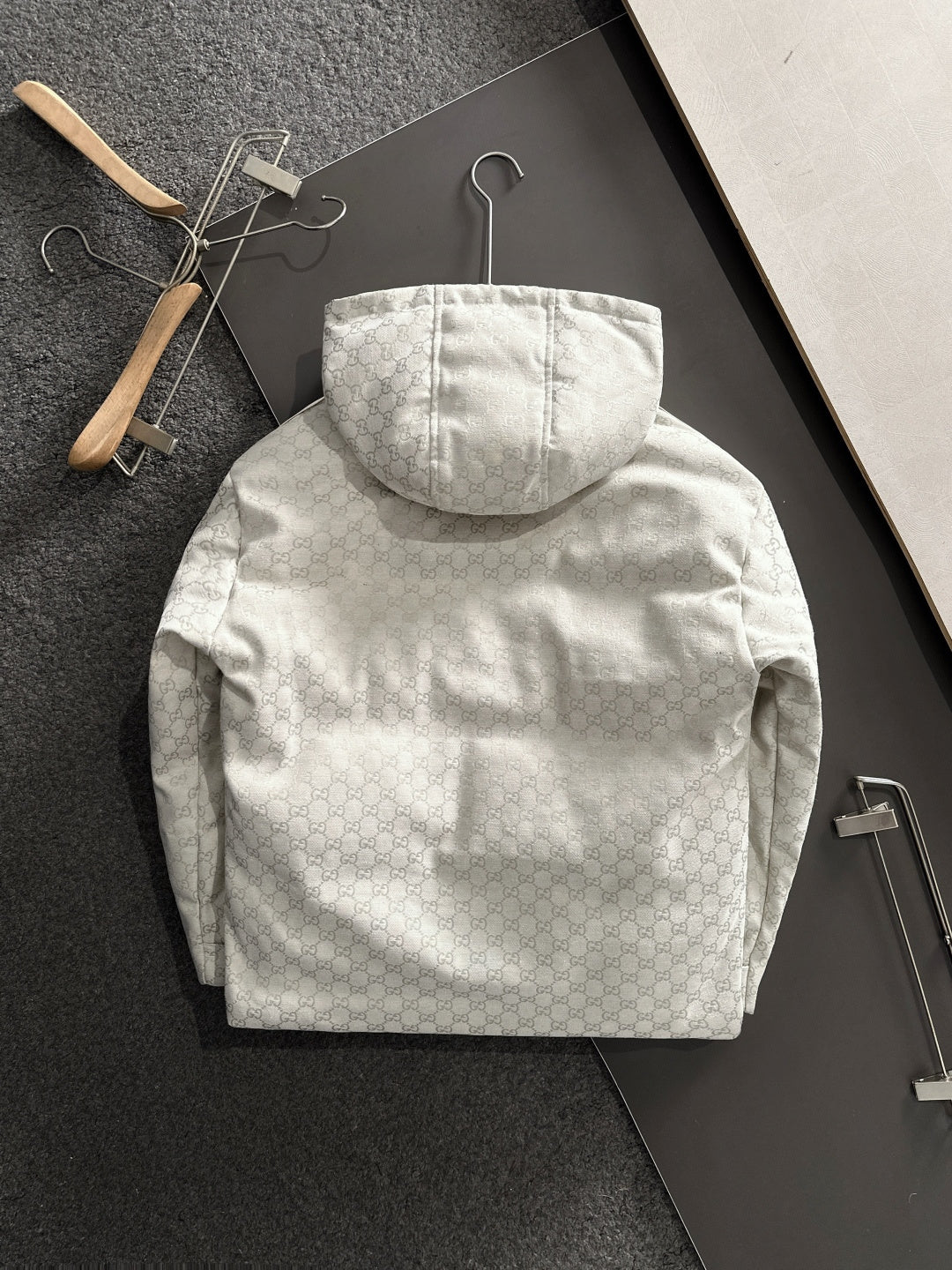 Gucci hooded jacket back view, light-gray monogram, central hood and pockets