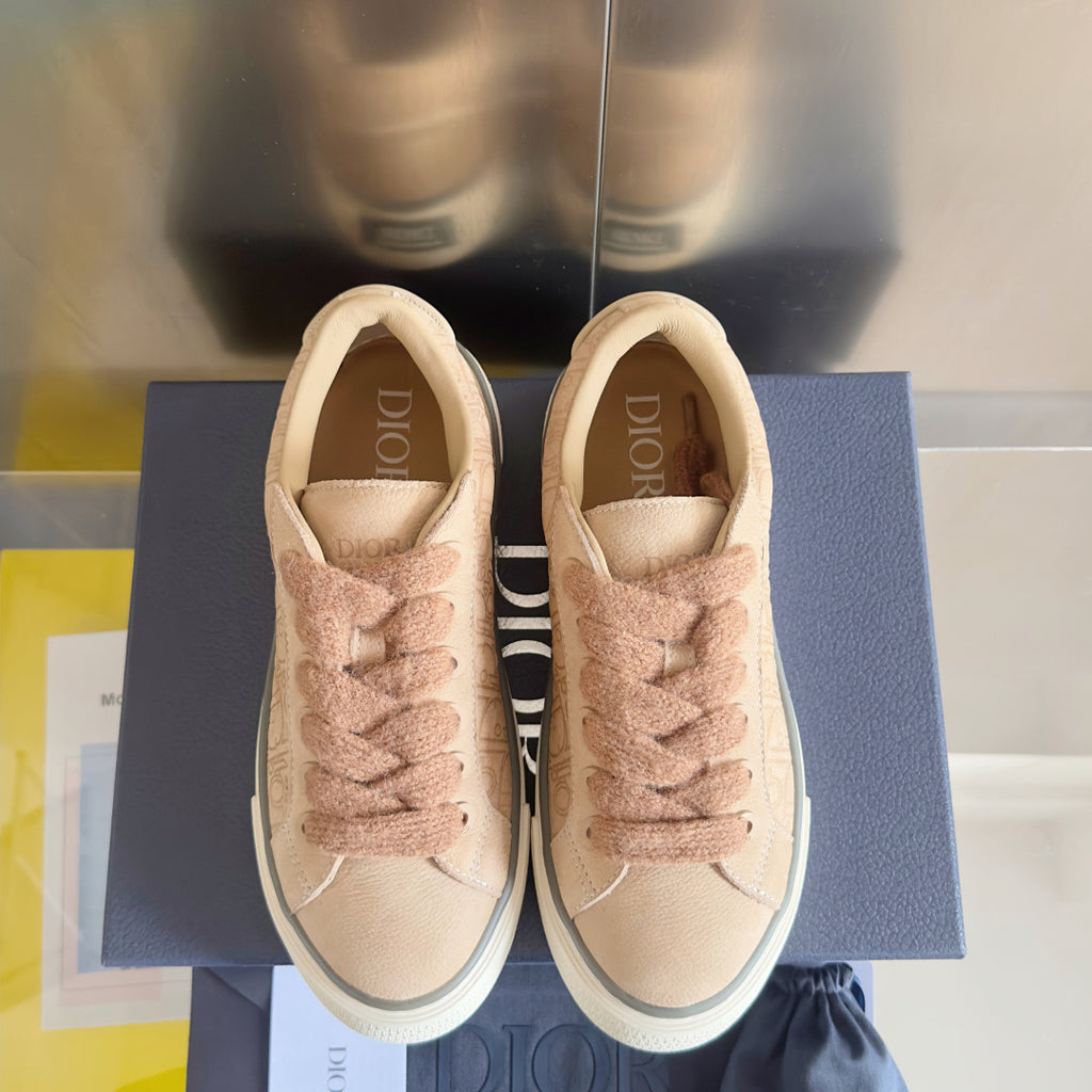 Dior unisex sneakers with beige uppers, lace-up front, visible Dior logo inside