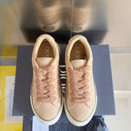 Dior unisex sneakers with beige uppers, lace-up front, visible Dior logo inside