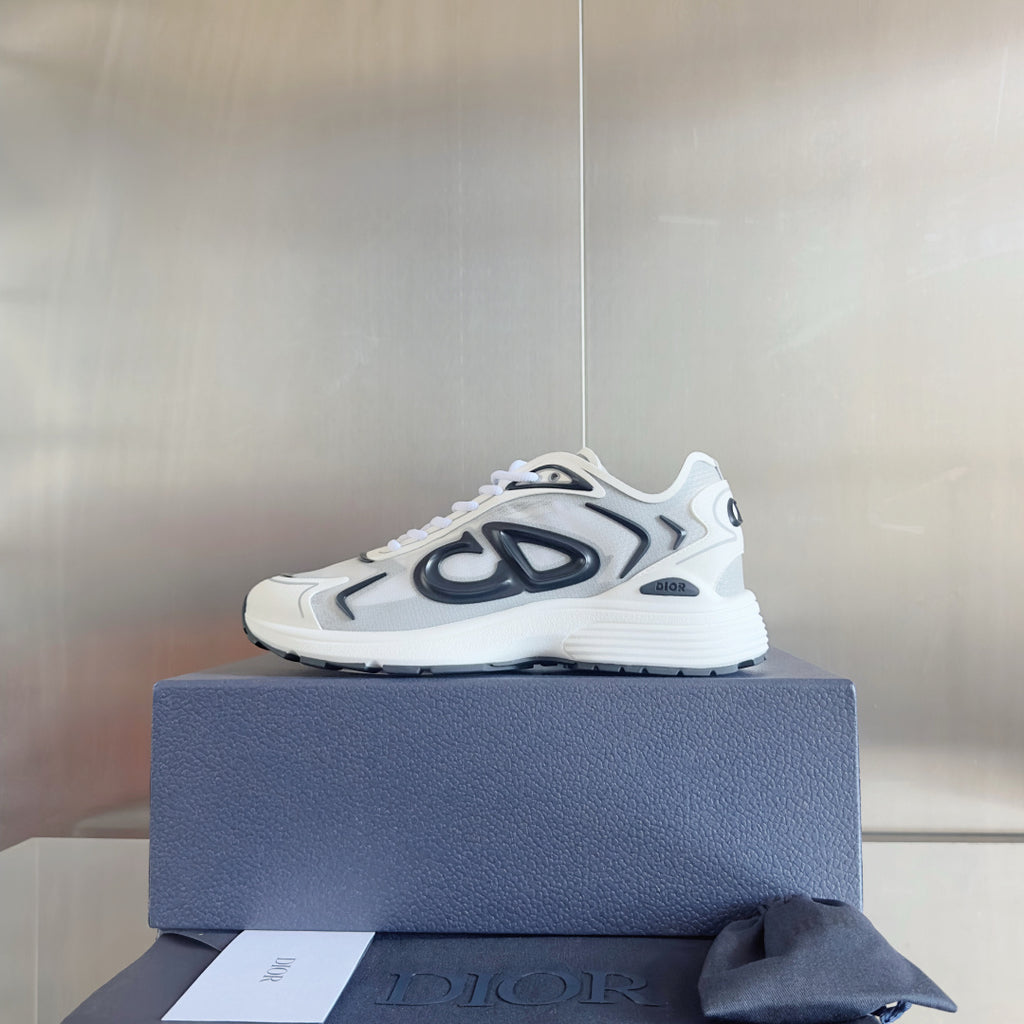 White and black logo sneakers, lace-up front, set on a blue shoebox.