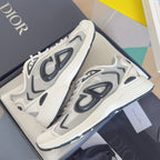 Pair of white sneakers with black logo graphics and textured, ribbed midsole.