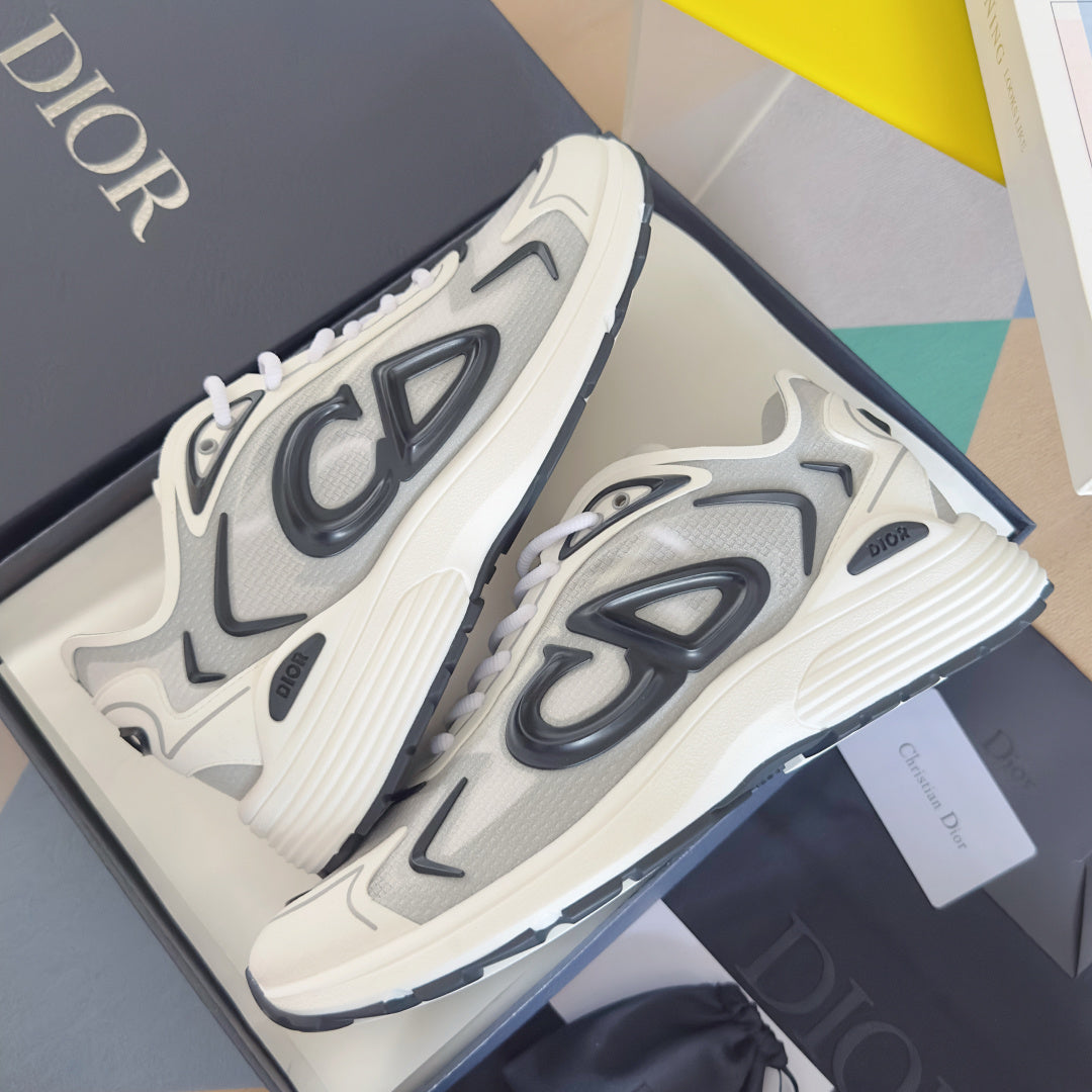Pair of white sneakers with black logo graphics and textured, ribbed midsole.