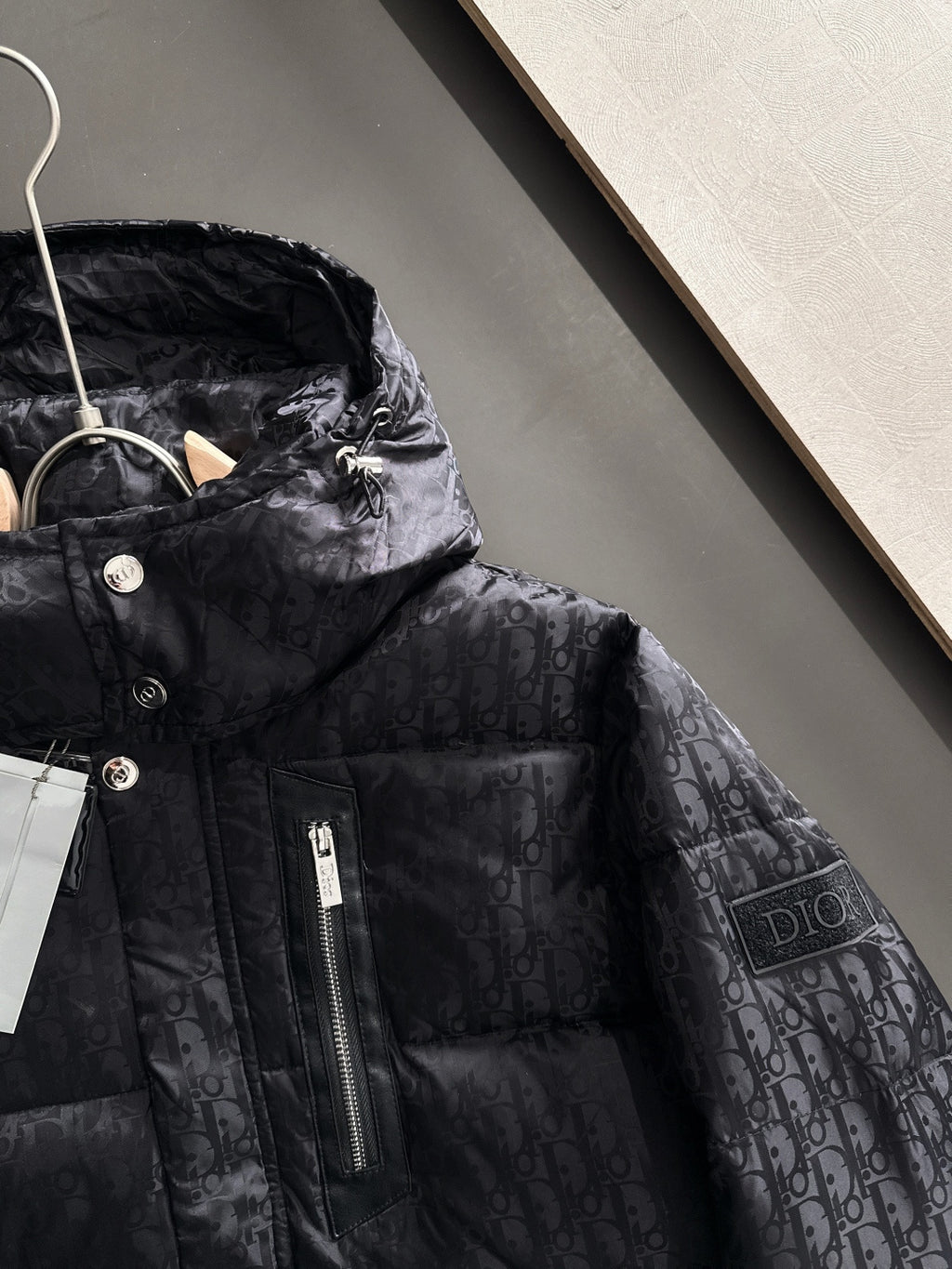 Black hooded puffer jacket with front zipper, Dior monogram fabric, snap buttons