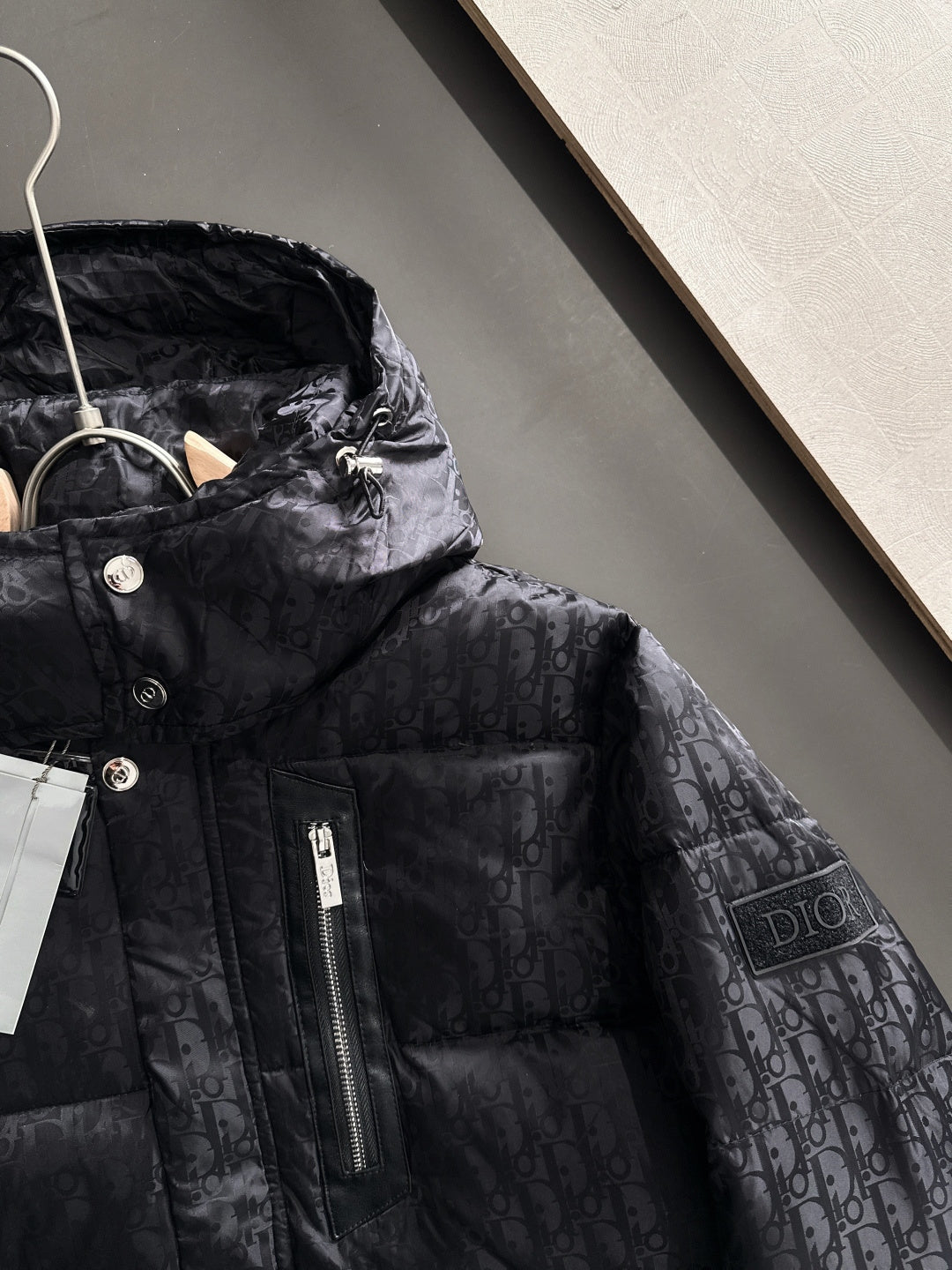 Black hooded puffer jacket with front zipper, Dior monogram fabric, snap buttons