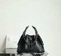 Chanel black quilted leather bucket bag with chain handles and CC logo