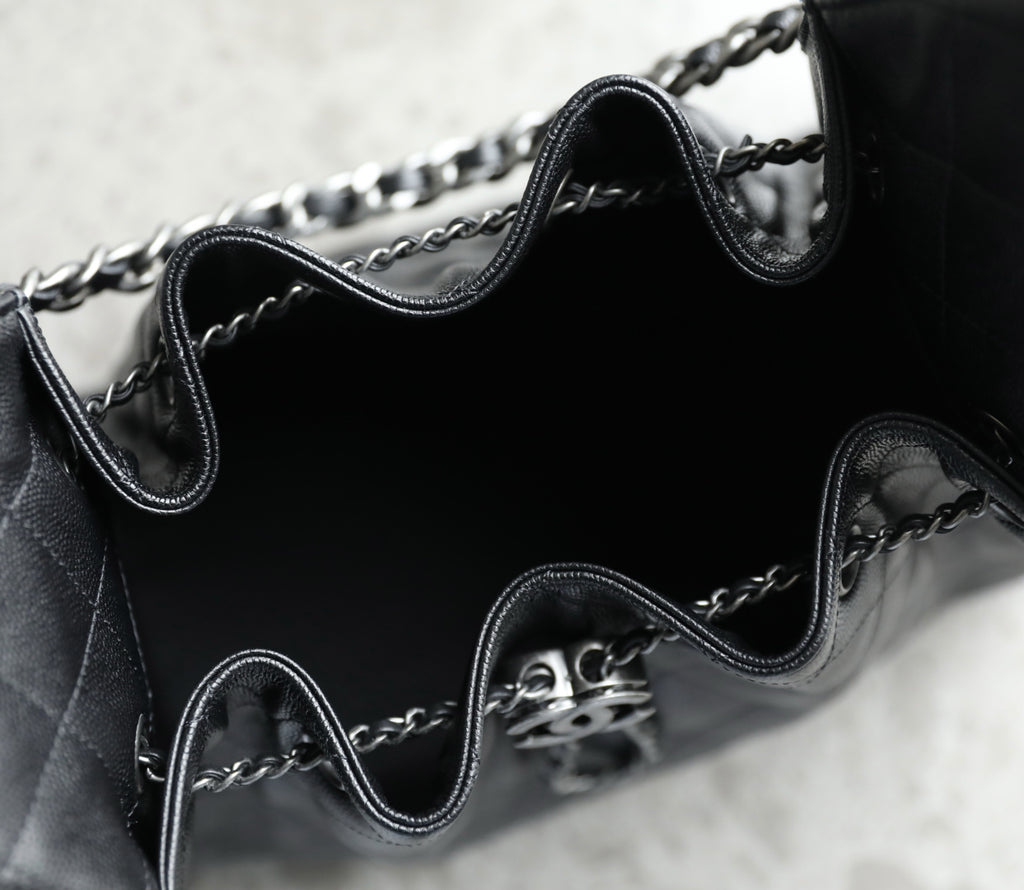 Chanel black leather bag interior with chain strap and metal CC clasp