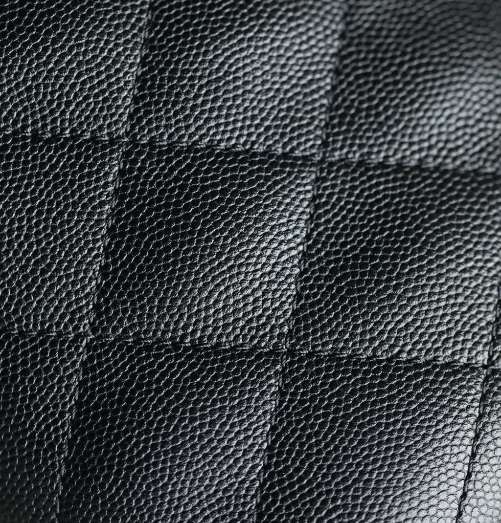 Chanel black quilted leather texture close-up with diamond stitching