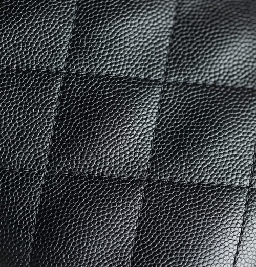 Chanel black quilted leather texture close-up with diamond stitching
