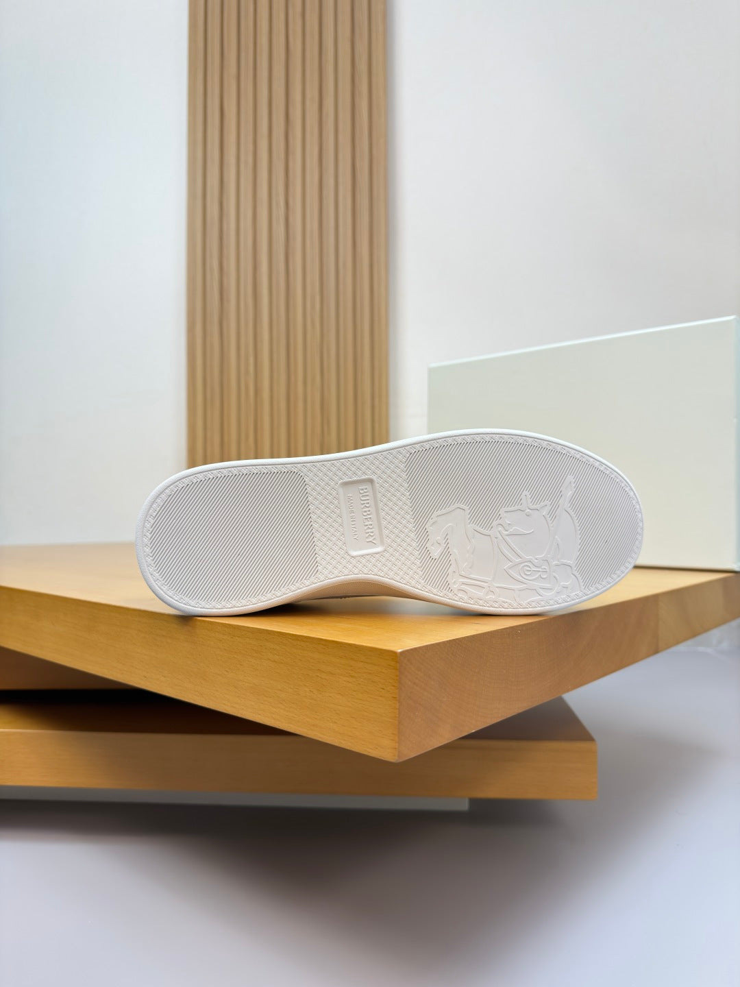White sneaker outsole with embossed design and traction pattern