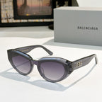 Balenciaga sunglasses, black frames with purple-tinted lenses and gold logo
