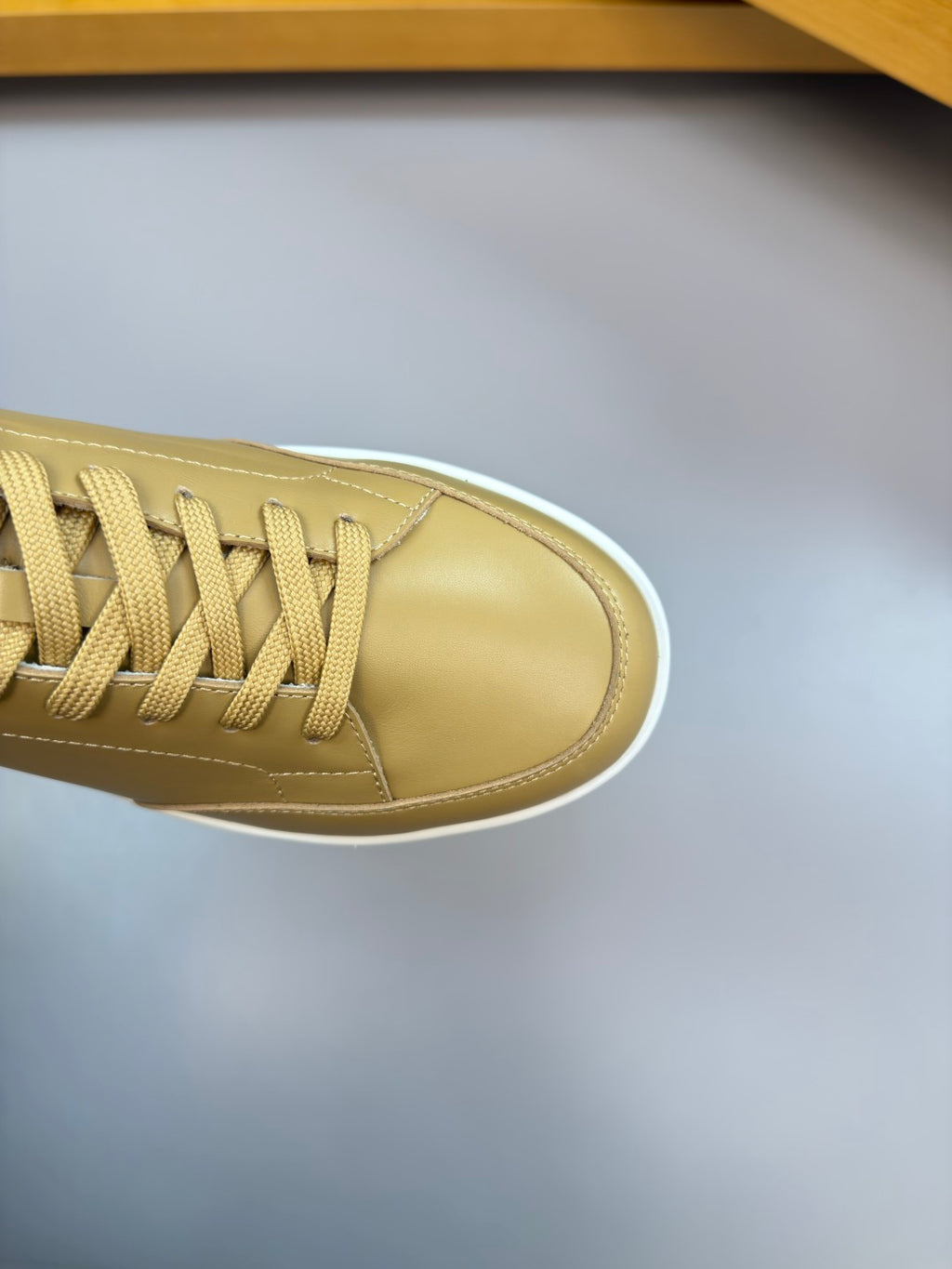 Burberry light tan sneaker toe and laces, close-up of side panel