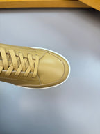 Burberry light tan sneaker toe and laces, close-up of side panel
