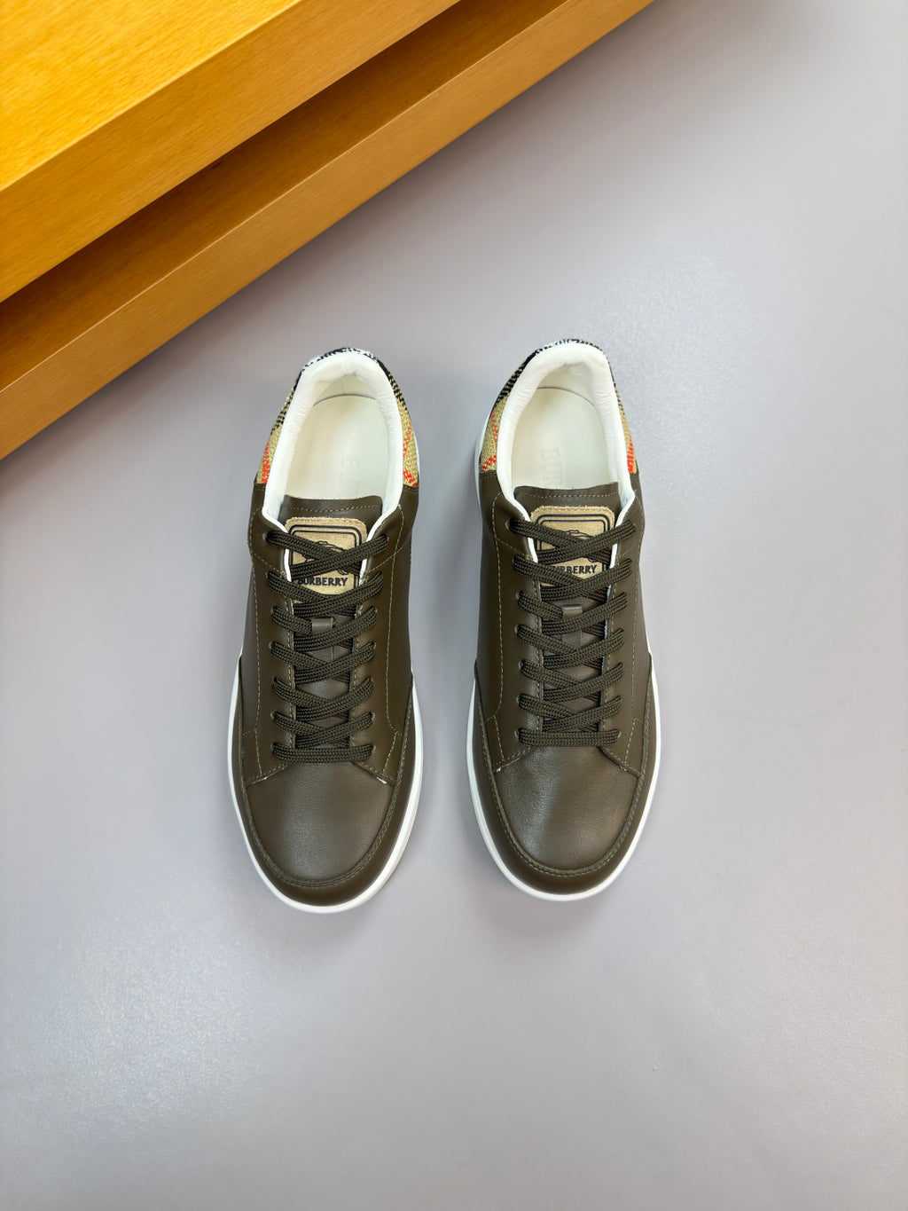 Burberry leather low-top sneakers, dark olive uppers with lace-up front and white sole