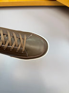 Close-up of dark brown sneaker with lace-up eyelets and white edge sole
