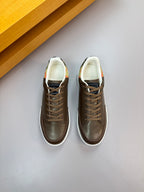 Pair of dark brown lace-up sneakers with white midsoles and patterned lining detail
