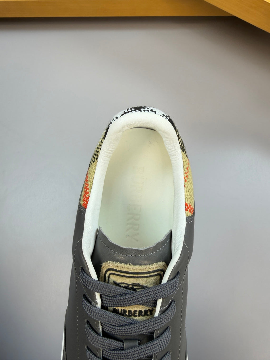Dark navy sneaker interior with lace-up collar and embroidered logo patch