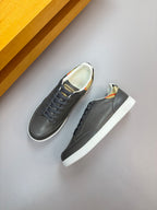 Dark navy leather low-top sneakers, side view with white rubber soles