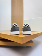 Back of dark navy low-top sneakers with check-print heel collar and white sole