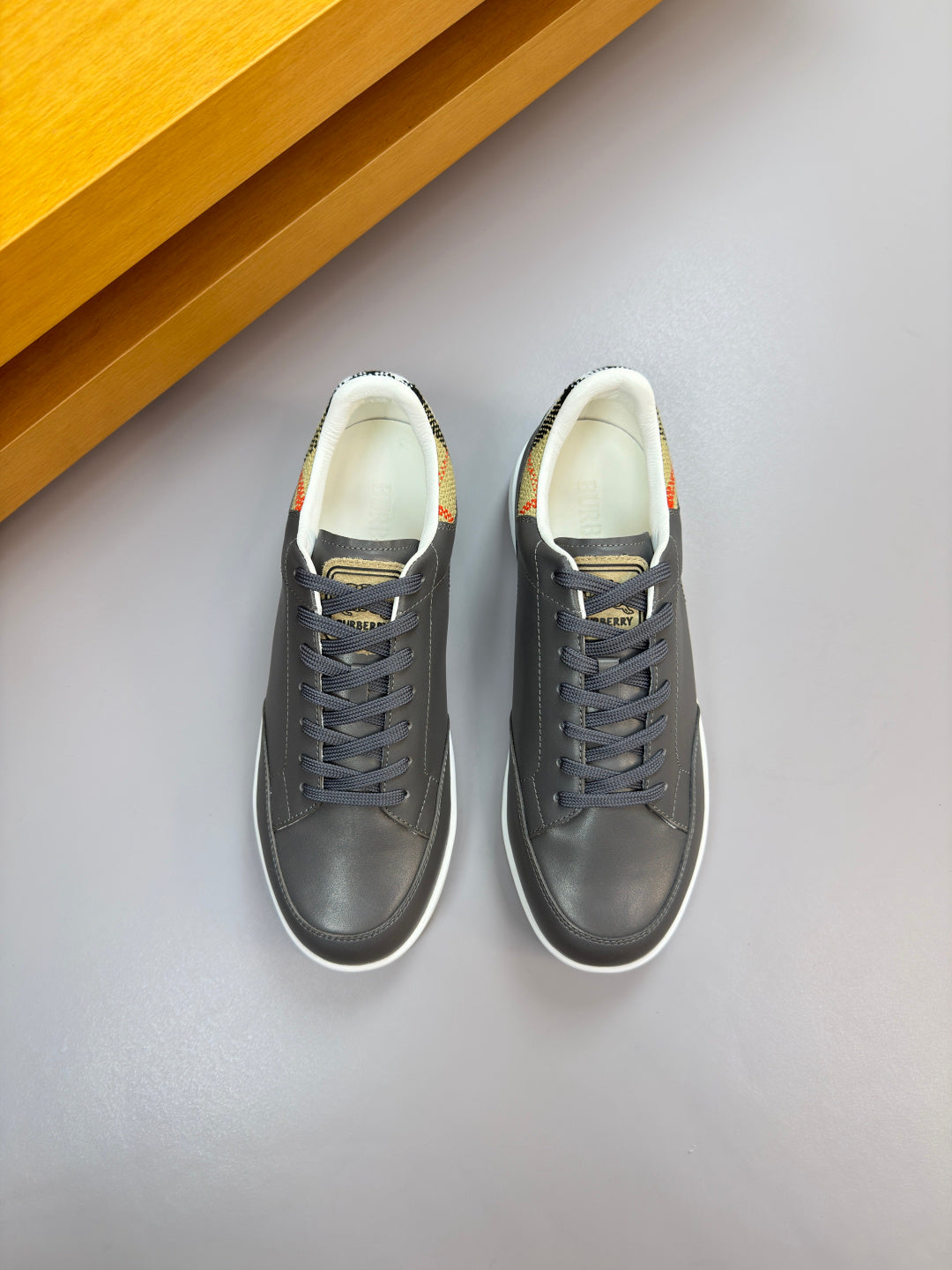Dark navy lace-up sneakers with white sole, front side view