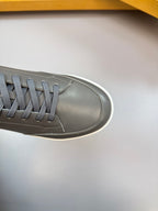 Close-up of dark navy sneaker toe and laces, white rubber trim