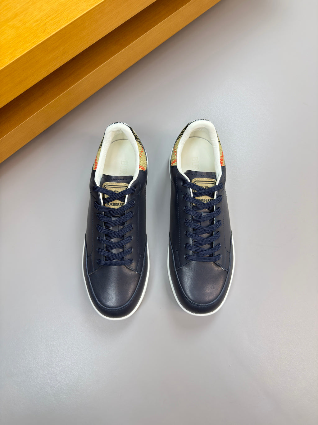 Burberry navy sneakers, lace-up front with white lining and low-profile sole