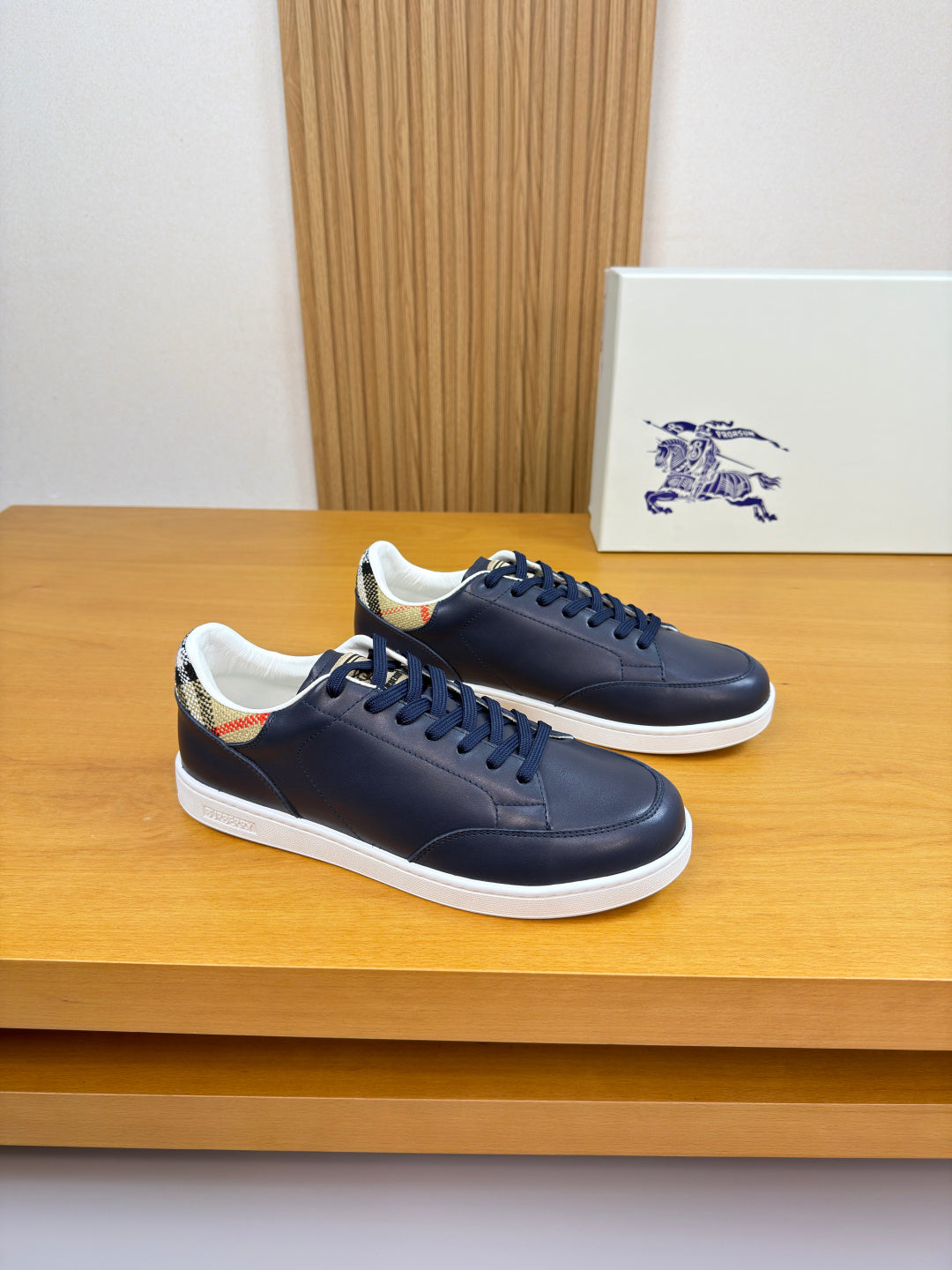 Burberry navy leather low-top sneakers with blue laces and white rubber sole