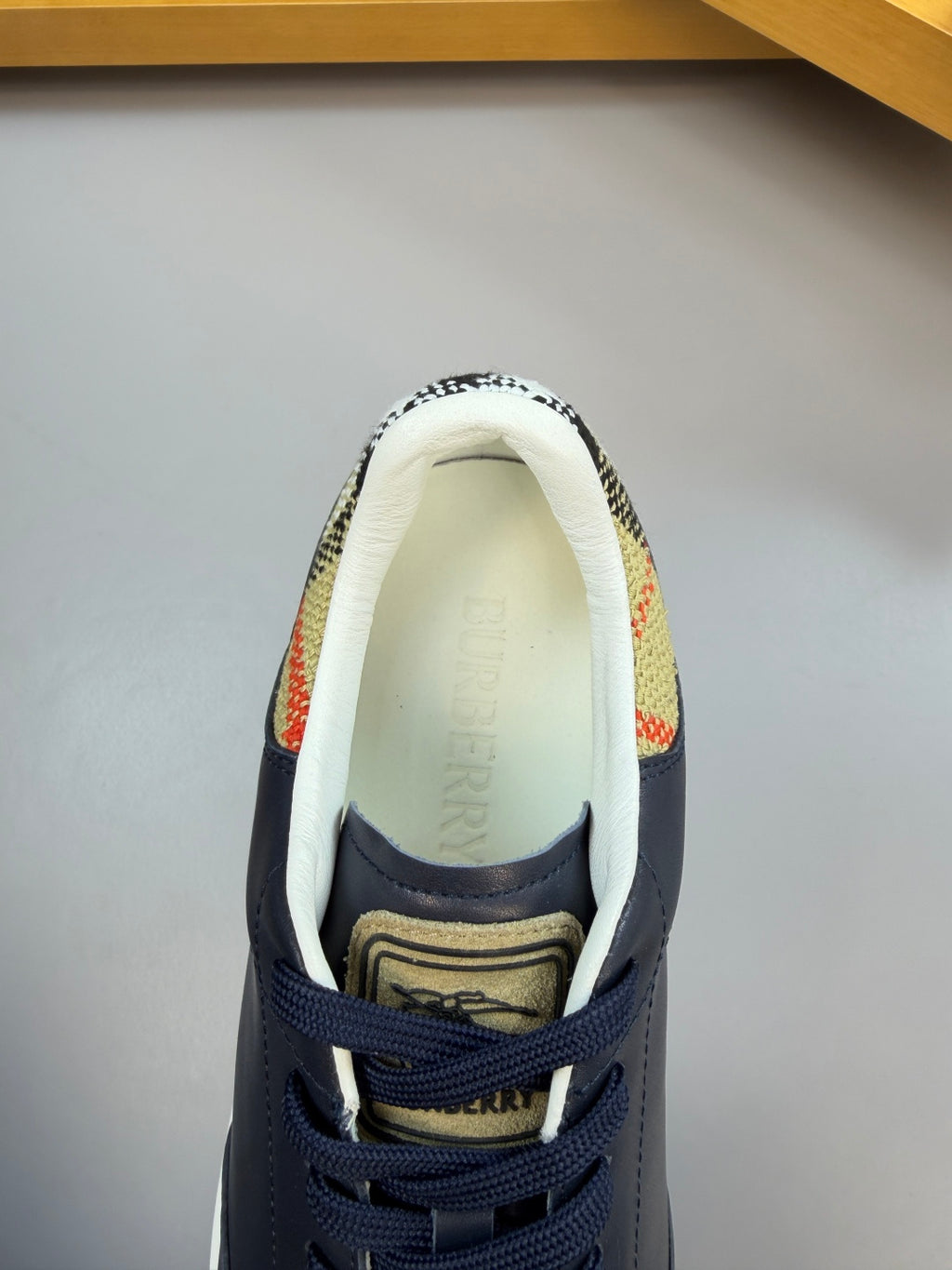 Burberry sneaker interior showing patterned lining and cushioned off-white insole