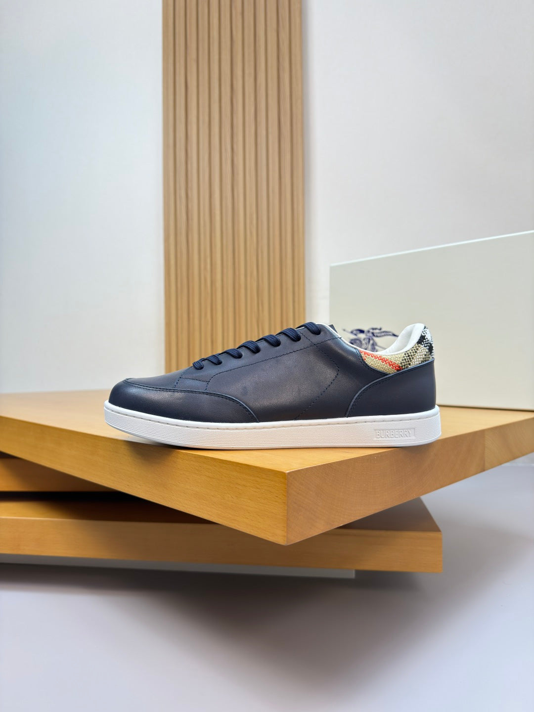 Burberry navy lace-up sneakers with white sole and multicolor patterned details
